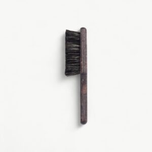 Professional Rodeo fade brush in S format for clearing loose hair and checking blend transitions.