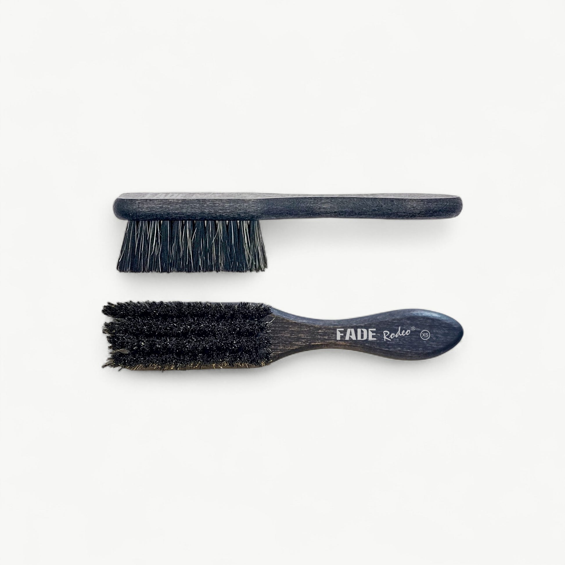Professional Rodeo fade brush in XS format for clearing loose hair and checking blend transitions.